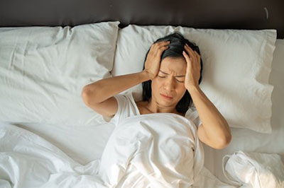Woman Experiencing Tinnitus-while Lying in Bed