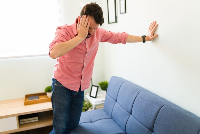 Stressed hispanic man about to faint